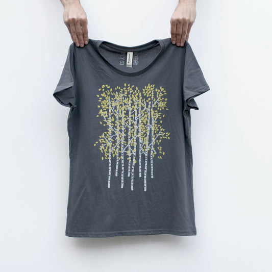 A women's organic cotton / recycled polyester t-shirt with a hand printed image of several Aspen trees with bright yellow leaves.