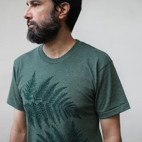 Close up image of a men's 50/50 tee with a hand printed image of 2 oversized Fern leaves on the front.